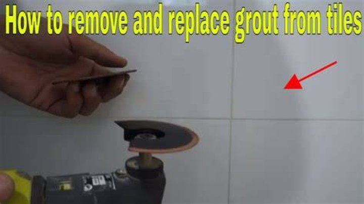 How do you remove black grout from white tiles?
